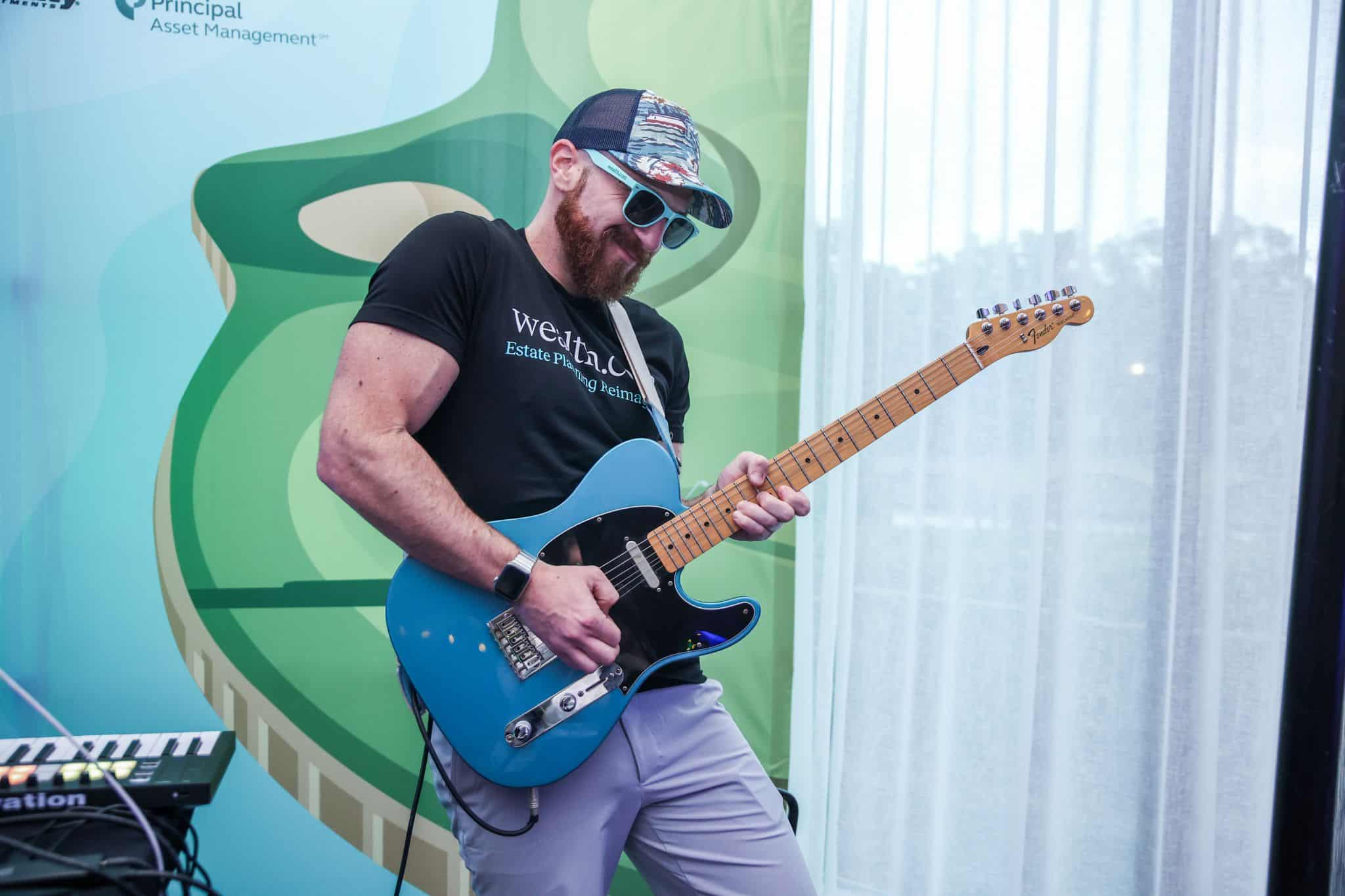 NPC Wealth.com playing guitar